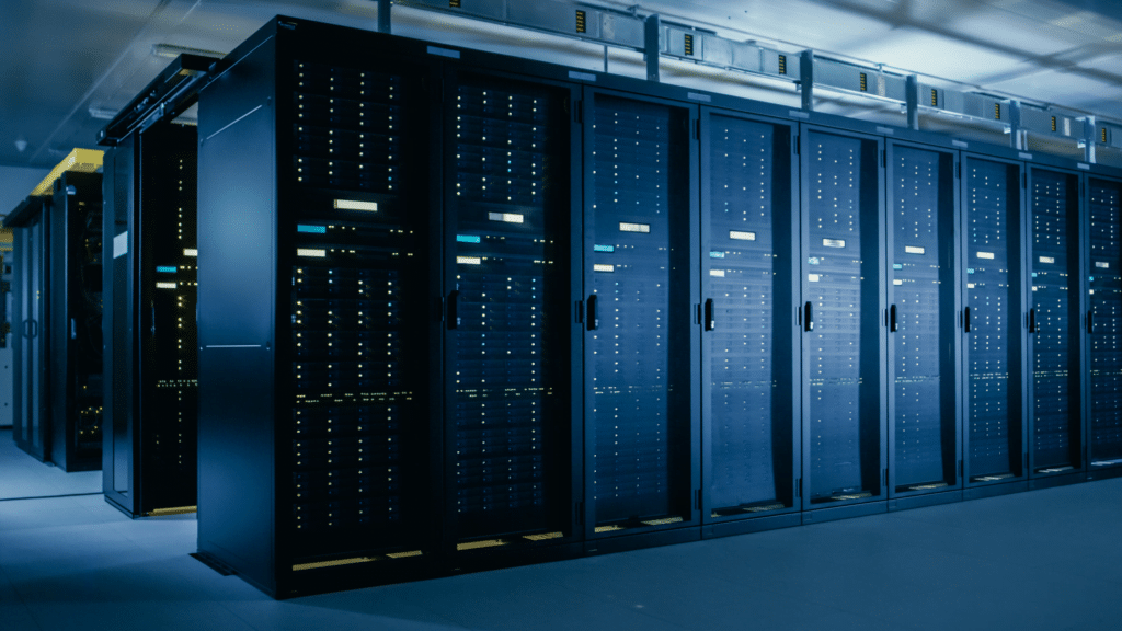 A row of black server racks filled with network equipment in a dimly lit data center showcases expert server and storage solutions. The room is illuminated by a cool blue light, highlighting the sleek design of the server cabinets.