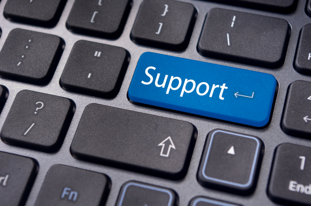 Close-up of a keyboard featuring a blue Help Desk Support key, cleverly replacing the usual enter key.