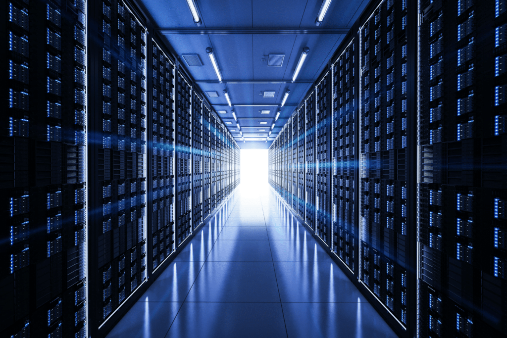 A futuristic data center hallway with rows of illuminated server racks on both sides. The perspective leads to a bright light at the end, embodying modern technological atmosphere and showcasing managed cloud solutions that enhance efficiency and innovation.