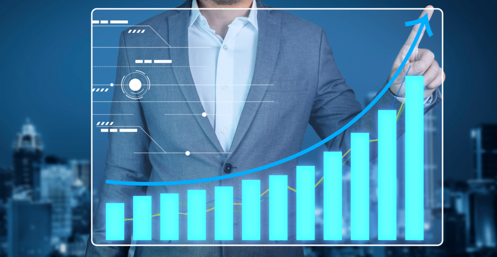 A person in a suit stands behind a digital screen displaying a glowing upward trend line and bar graph, symbolizing business success through affordable managed IT services. The blurred cityscape background highlights the theme of growth and efficiency in today’s competitive landscape.